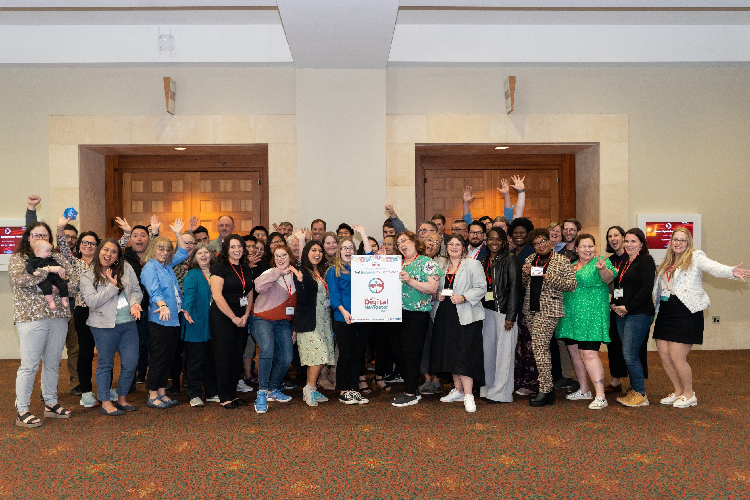 a group of people posing for a photo in a conference room