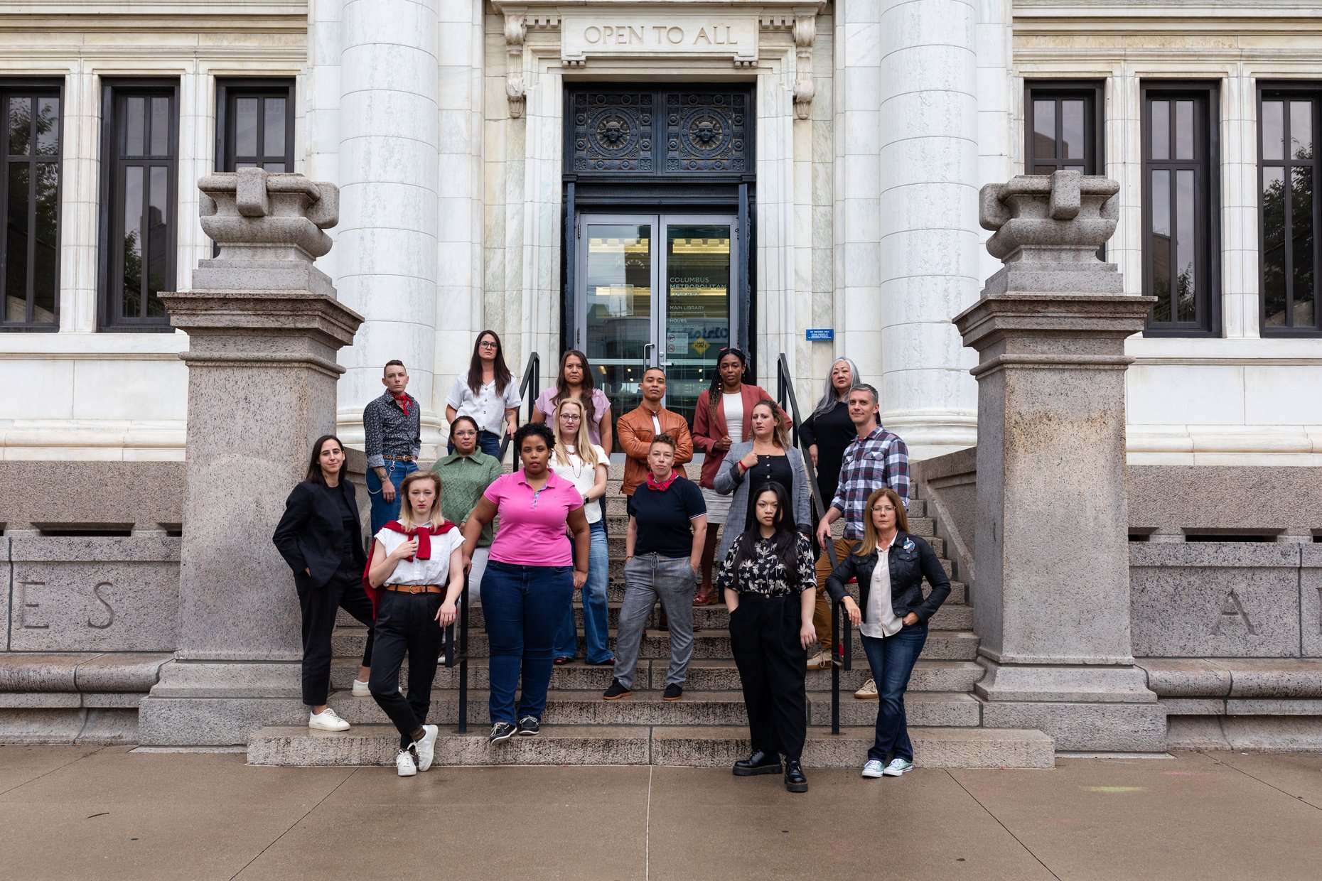 a group of people standing in front of a library